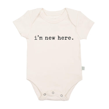 Graphic bodysuit for babies with "I'm New Here" design, perfect for newborn outfits and cute photo opportunities.