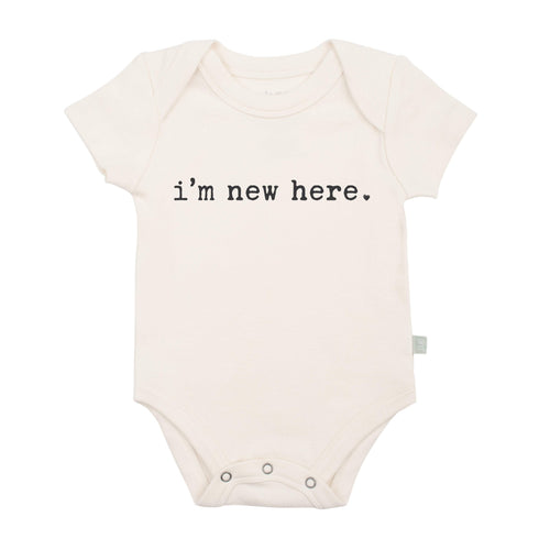 Graphic bodysuit for babies with "I'm New Here" design, perfect for newborn outfits and cute photo opportunities.