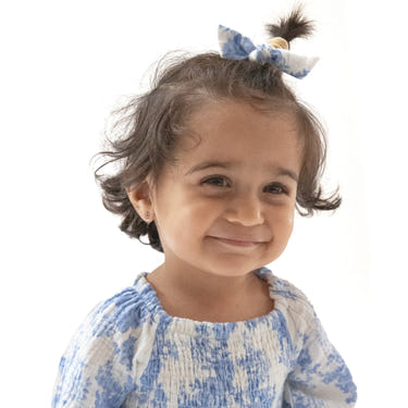Dream Cottage Floral bow with nylon headband for babies, perfect accessory for any seasonal outfit.