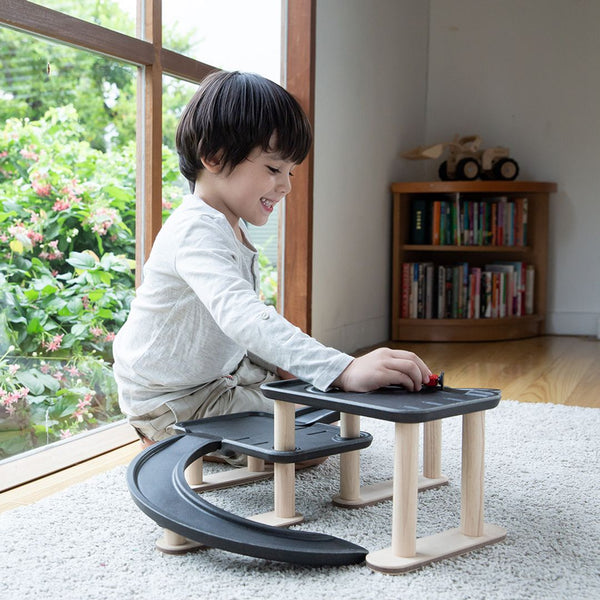 "Race N Play Parking Garage toy for babies, featuring colorful design and multiple levels for imaginative play."