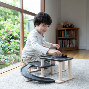 "Race N Play Parking Garage toy for babies, featuring colorful designs and multiple levels for fun playtime."