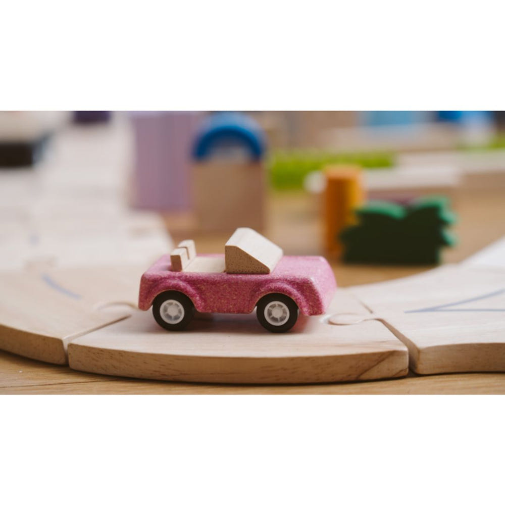 Pink sports car toy for babies, perfect for imaginative play and entertainment.