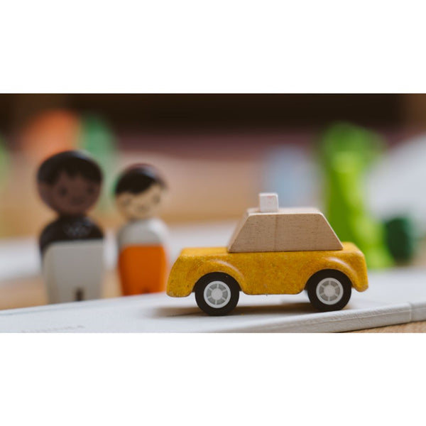 Yellow taxicab toy for babies, perfect for imaginative play and entertainment. Angle view showcasing its vibrant design.