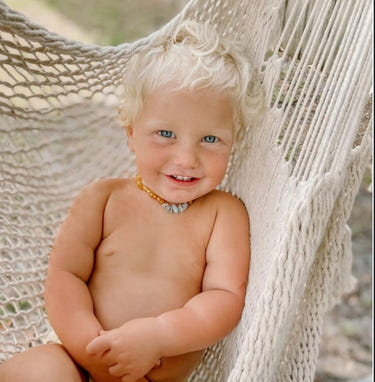 Raw honey Baltic amber and aquamarine baby necklace for teething relief and style.