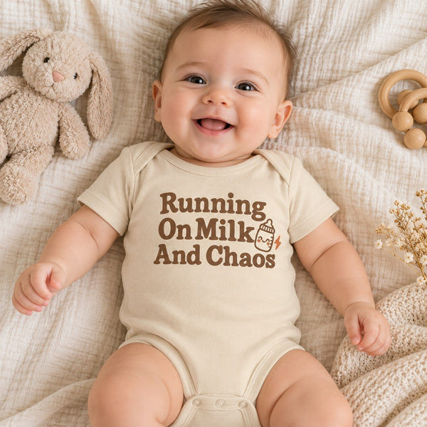 Baby wearing the Running On Milk And Chaos baby bodysuit