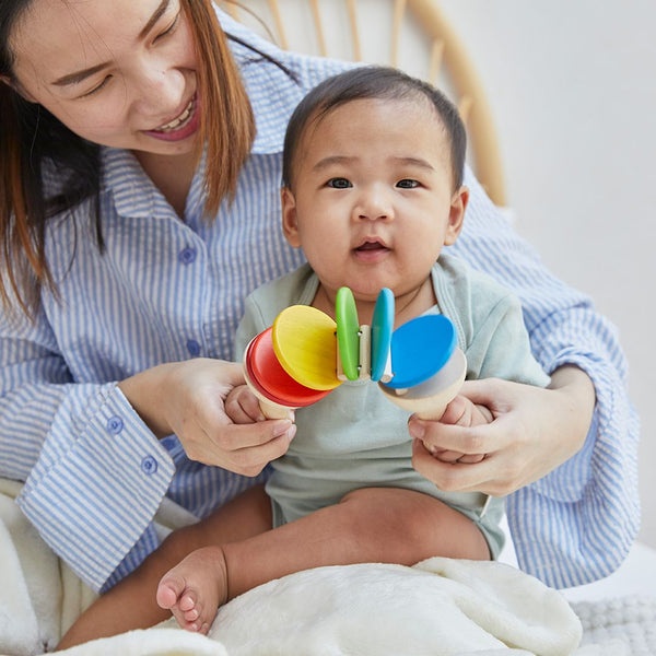 Colorful Clatter toy for babies, promoting early learning and sensory play from an engaging angle.