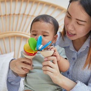 Colorful Clatter toy for babies, promoting early learning and sensory play, viewed from angle 4.