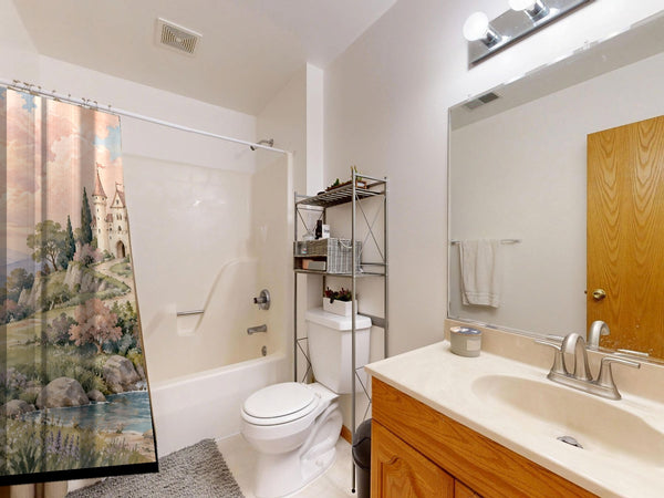 Hilltop Castle Fairy Tale shower curtain on a tub shower combo in an American family bathroom
