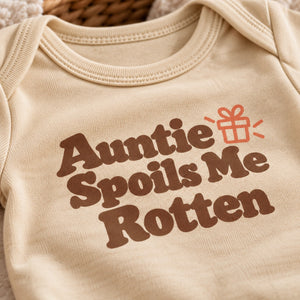 Close-up of the Auntie Spoils Me Rotten baby bodysuit print