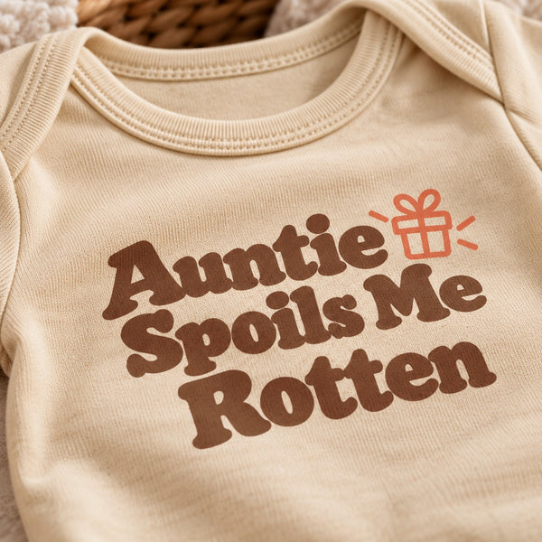 Close-up of the Auntie Spoils Me Rotten baby bodysuit print