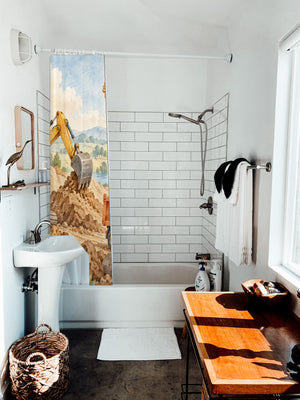 Construction Site shower curtain hanging on the rod over a white bathtub