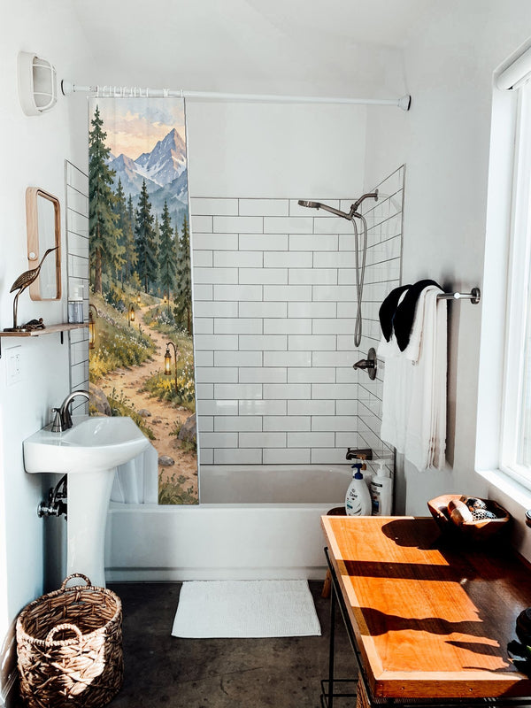 Mountain Camp Camping shower curtain hanging on the rod over a white bathtub