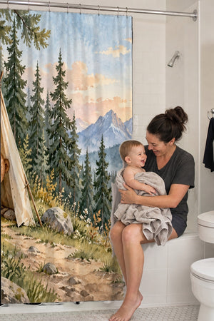 Mom holding her baby on the tub edge next to the Bear Tent Sunrise Camping shower curtain