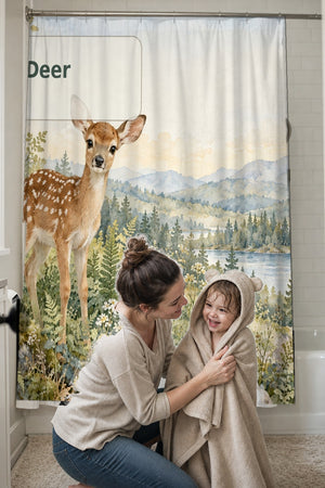 Mom drying her toddler in a hooded towel in front of the D is for Deer Alphabet shower curtain