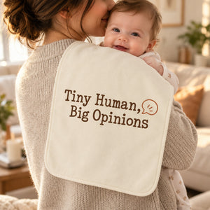 Tiny Human, Big Opinions burp cloth in cream, styled photo 1