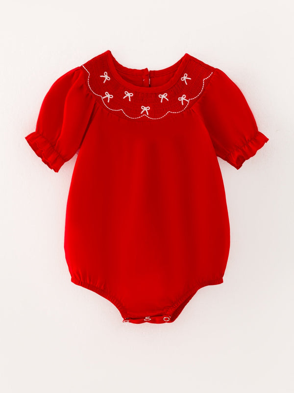 Girls red romper with bow smocking and embroidery, angle view 4, perfect for stylish baby outfits.