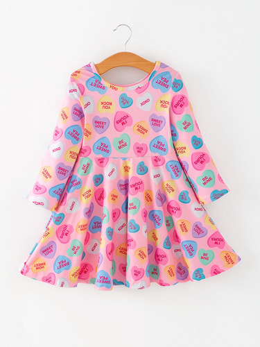 Toddler girls' Valentine dress featuring a colorful candy heart print, perfect for festive occasions.