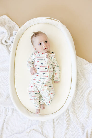 Tied with a Bow Christmas Bamboo Zippy Pajamas for babies, festive and cozy holiday sleepwear.