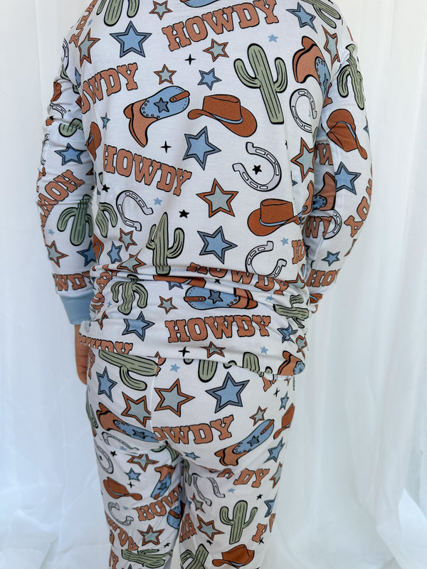 Howdy Partner Set sleepsuits and pyjamas for babies, displayed at an angle showcasing their cute design.