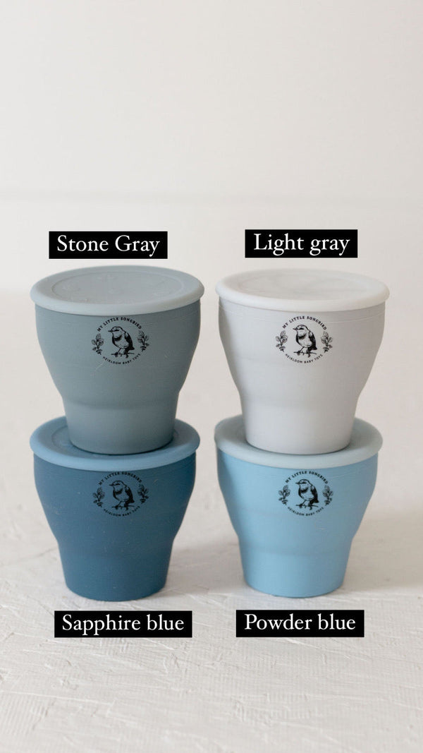 Silicone snack cups in various colors, collapsible design for easy storage, perfect for babies and toddlers.