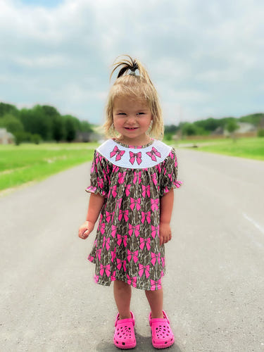 Smocked camo bows dress for babies, perfect for stylish and comfortable everyday wear.