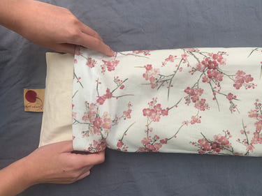 Hot Cherry cervical neck pillow in unbleached denim with cherry blossom pillowcase, perfect for comfort and support.