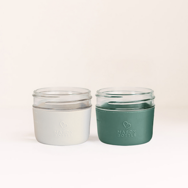 Silicone sleeve for cups, 2 pack, in various colors, designed for baby drinkware, angle view.