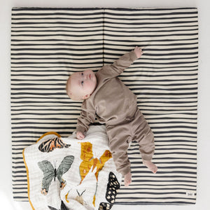 Bold stripe organic cotton play mat angled view, perfect for baby playtime and comfort.