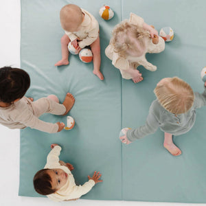 Sage Vegan Leather Play Mat at angle 8, perfect for stylish and safe baby playtime.