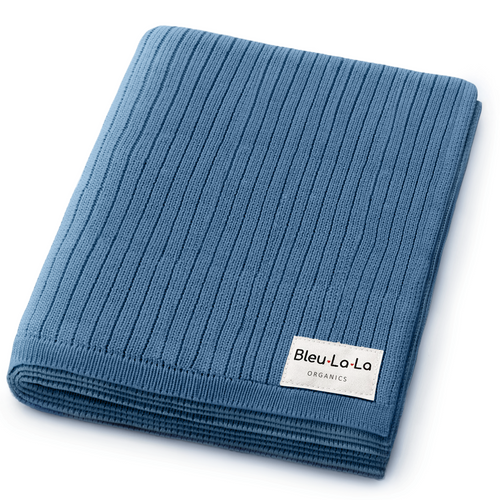 Organic ribbed knit cotton baby blanket in soft colors, angled view showcasing texture and comfort for infants.