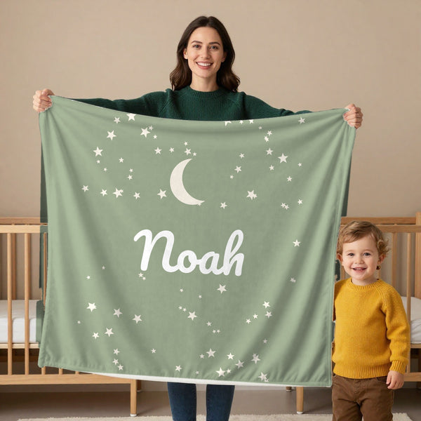 Moon and Stars toddler minky blanket in sage, held by a mom