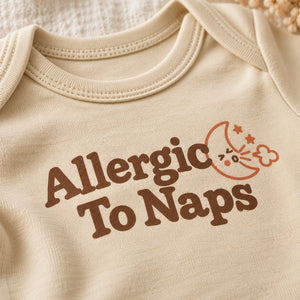 Close-up of the Allergic To Naps baby bodysuit print