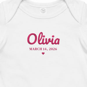 Embroidered name and birth date on the chest of the baby bodysuit