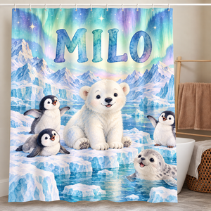Personalized polar bear and penguin shower curtain with the name Milo hanging in a kids bathroom