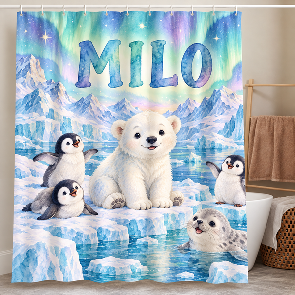 Personalized polar bear and penguin shower curtain with the name Milo hanging in a kids bathroom