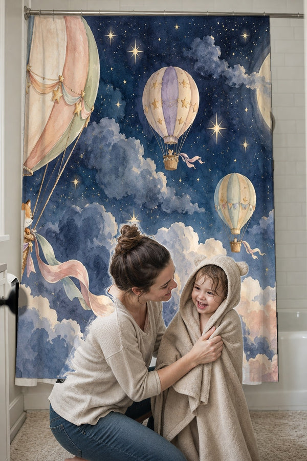 Mom drying her toddler in a hooded towel in front of the Moonlit Flight Hot Air Balloon shower curtain