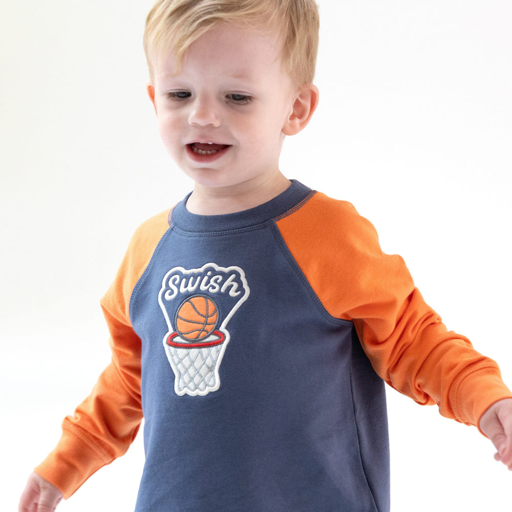 Varsity basketball raglan sweatshirt for babies, stylish and cozy for little sports fans.