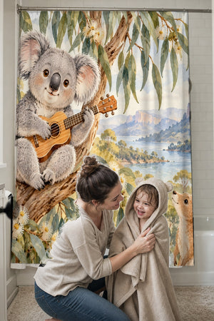 Mom drying her toddler in a hooded towel in front of the Koala Ukulele shower curtain