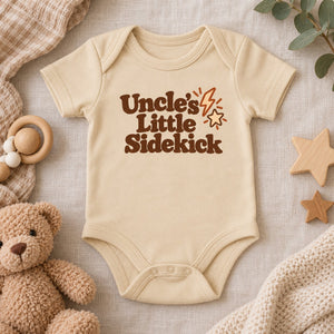 Styled flat lay of the Uncle's Little Sidekick baby bodysuit