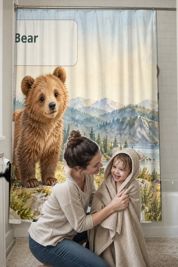 Mom drying her toddler in a hooded towel in front of the B is for Bear Alphabet shower curtain