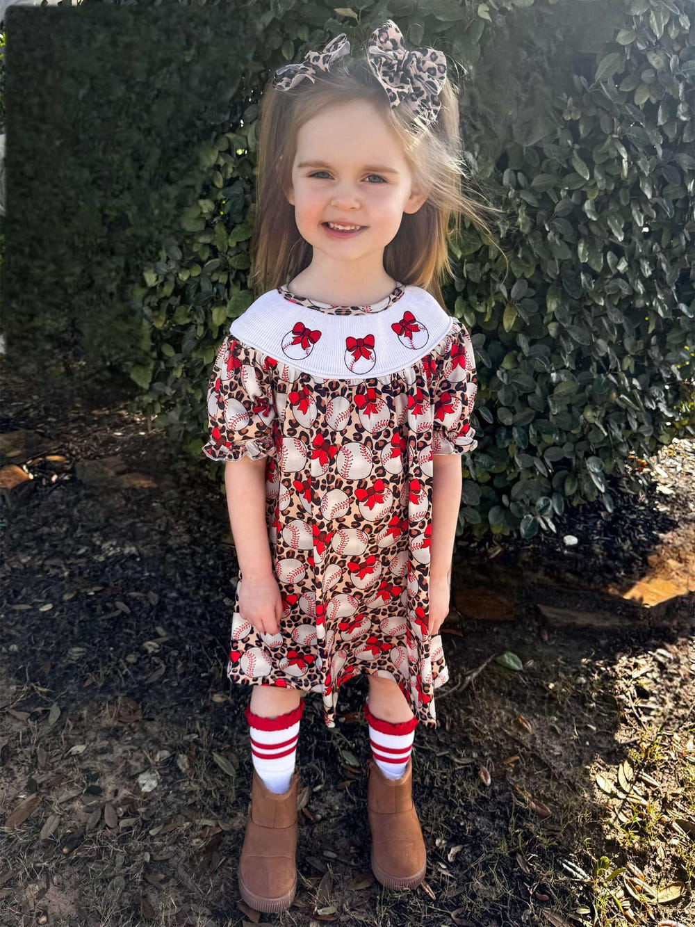 Smocked leopard baseball dress for babies, stylish and playful design for little ones.