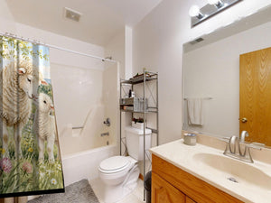 Lamb Meadow Farm shower curtain on a tub shower combo in an American family bathroom