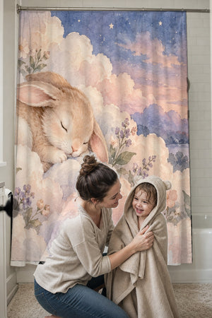 Mom drying her toddler in a hooded towel in front of the Cloud Bunny shower curtain