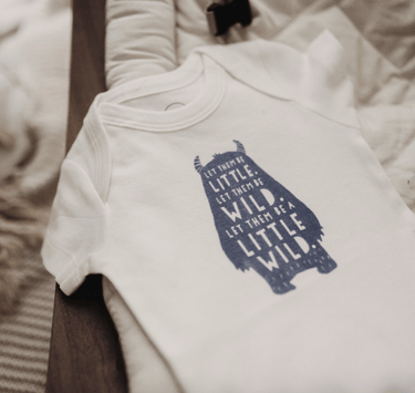 "Wild Child graphic short sleeve bodysuit for babies, perfect for playful and adventurous little ones."