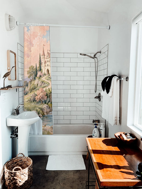 Hilltop Castle Fairy Tale shower curtain hanging on the rod over a white bathtub
