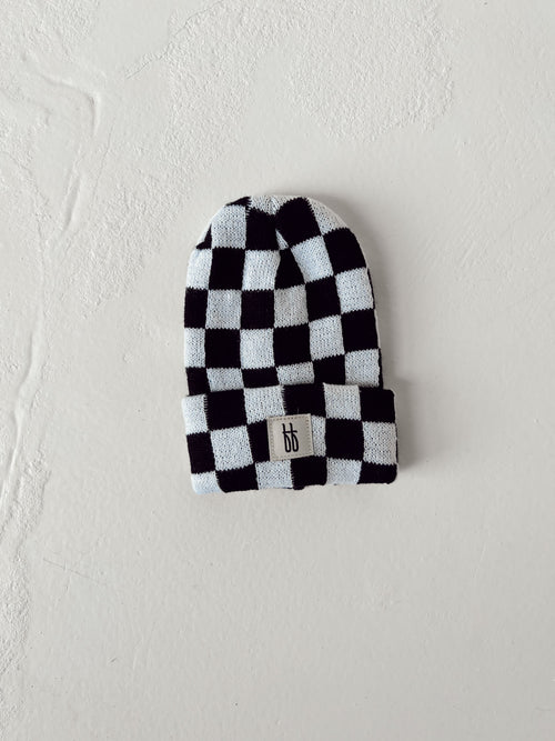 Black and white checkerboard knit beanie for babies, stylish and cozy accessory for little ones.