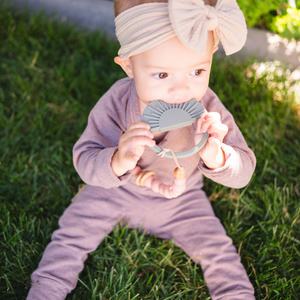 Sage Sunburst Teething Toy at angle 7, perfect for soothing baby's gums with a stylish design.