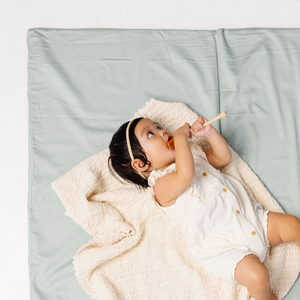 Sage + Breeze Organic Cotton Play Mat at angle 2, featuring soft, eco-friendly fabric for baby's comfort and playtime.