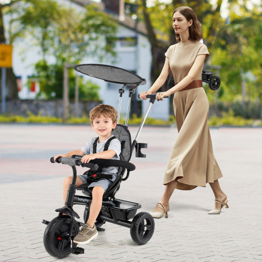 7-in-1 Baby Stroller Tricycle in gray with adjustable canopy and foldable footrests for ages 9-60 months, angle view.