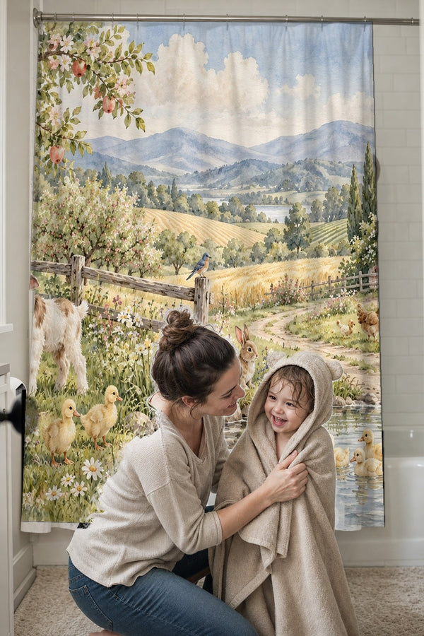 Mom drying her toddler in a hooded towel in front of the Peaceful Farm shower curtain